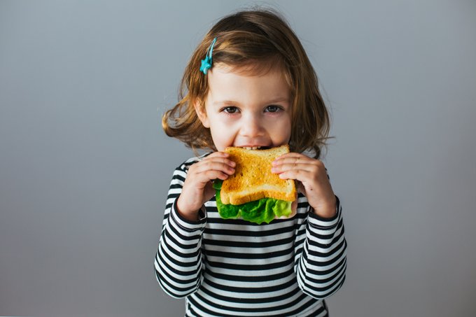 Young child eating a sandwich