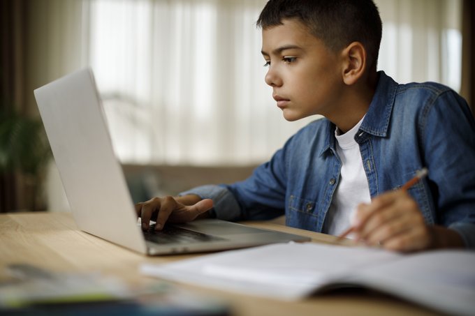 middle school student working on laptop