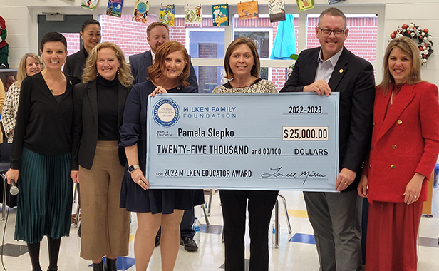 Milken Award winner Pamela Stepko hold $25,000 award check with State Superintendent Jillian Balow and First Lady Suzanne Youngkin at Cumberland Elementary School.