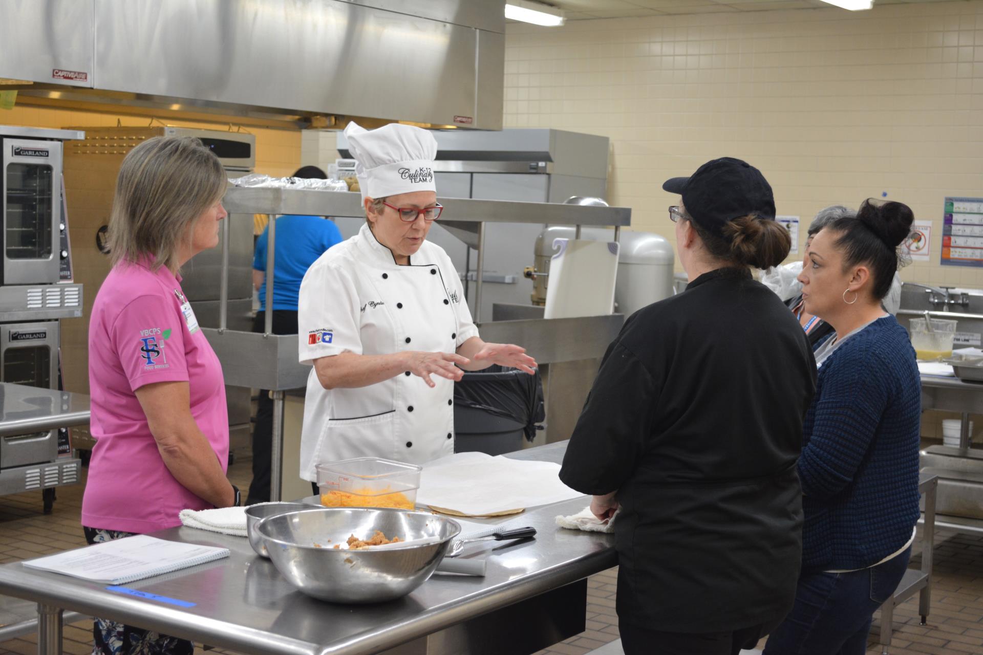 Cafeteria managers learning scratch-cooking methods during the Team Nutrition Readiness and Retention Training program.
