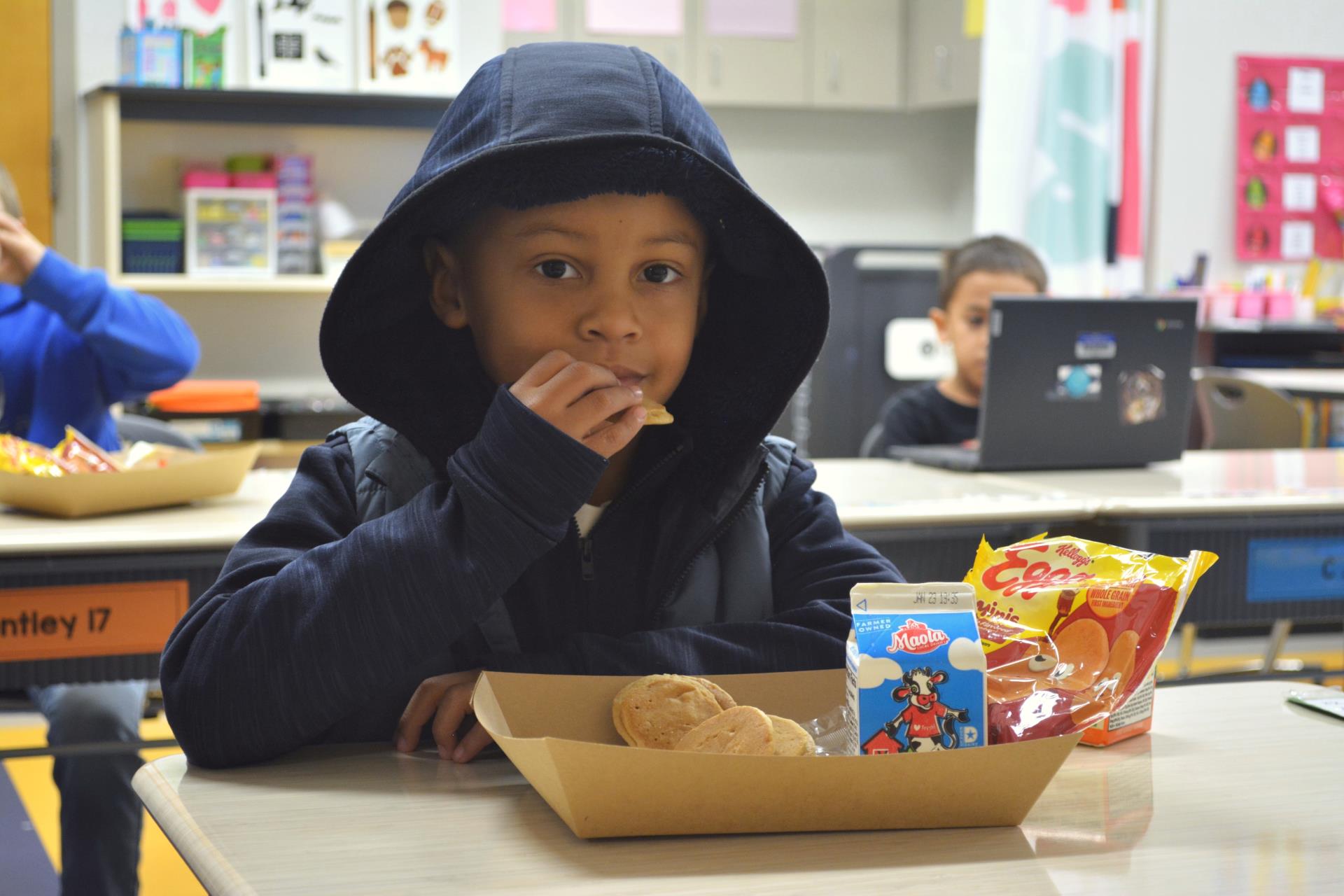 Student eating grab and go breakfast in the classroom.