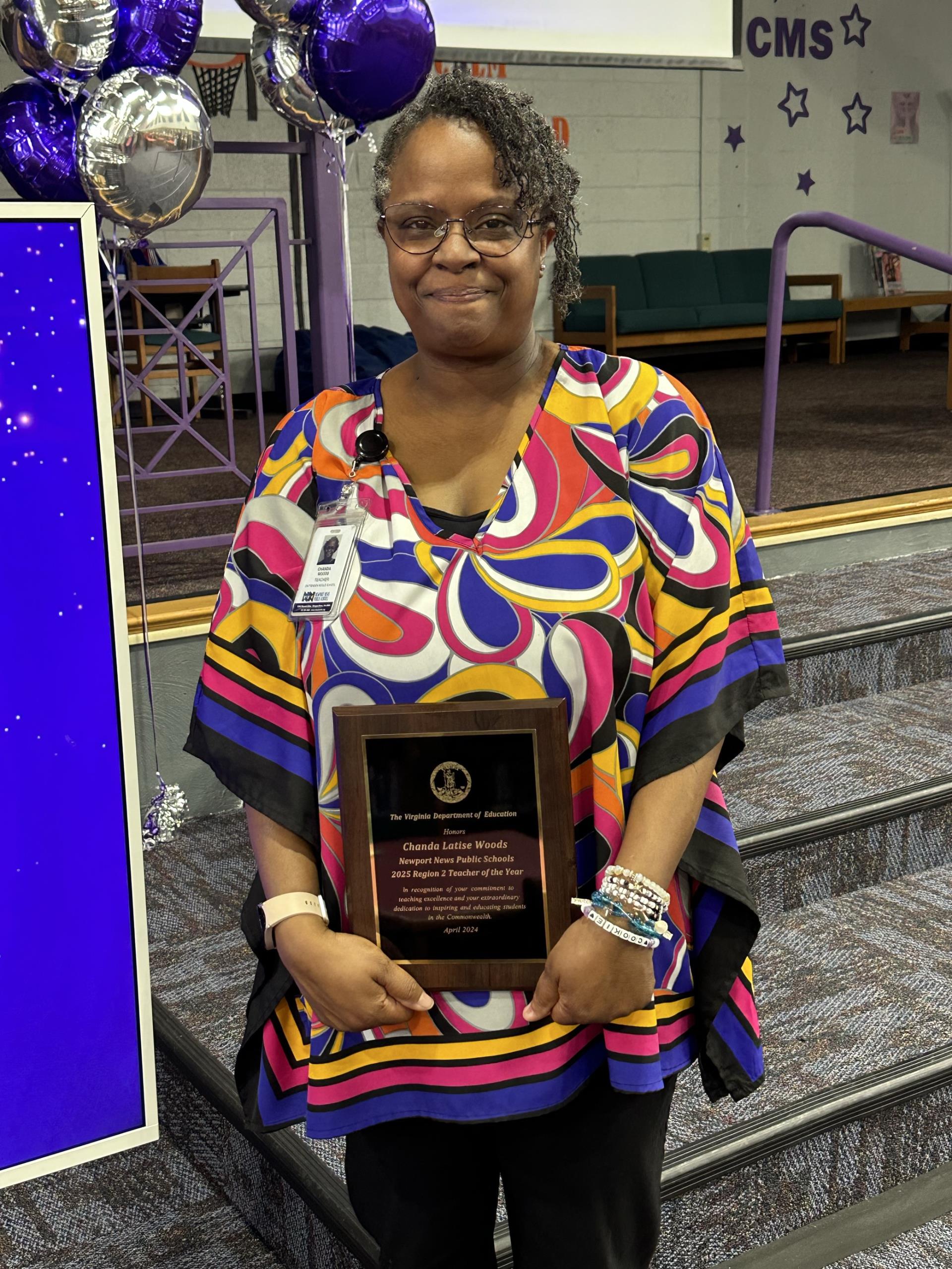 Chanda Woods holds Regional Teacher of the Year plaque